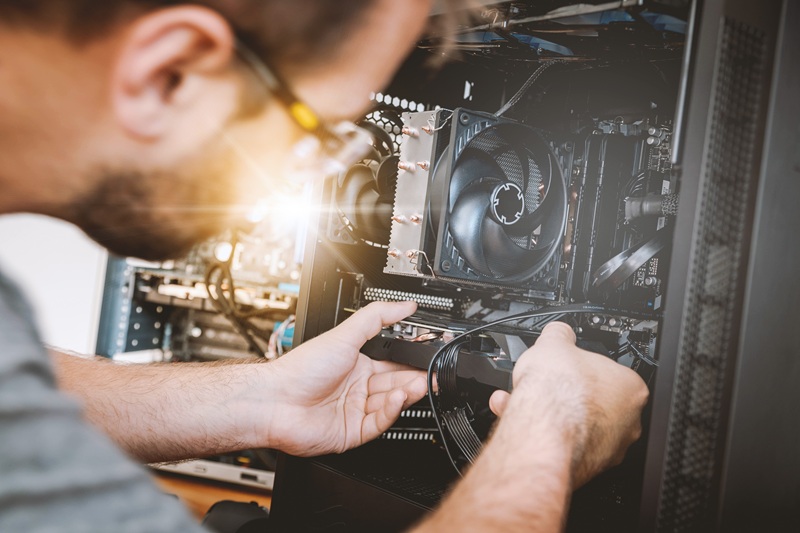 Someone inserting a GPU in a computer